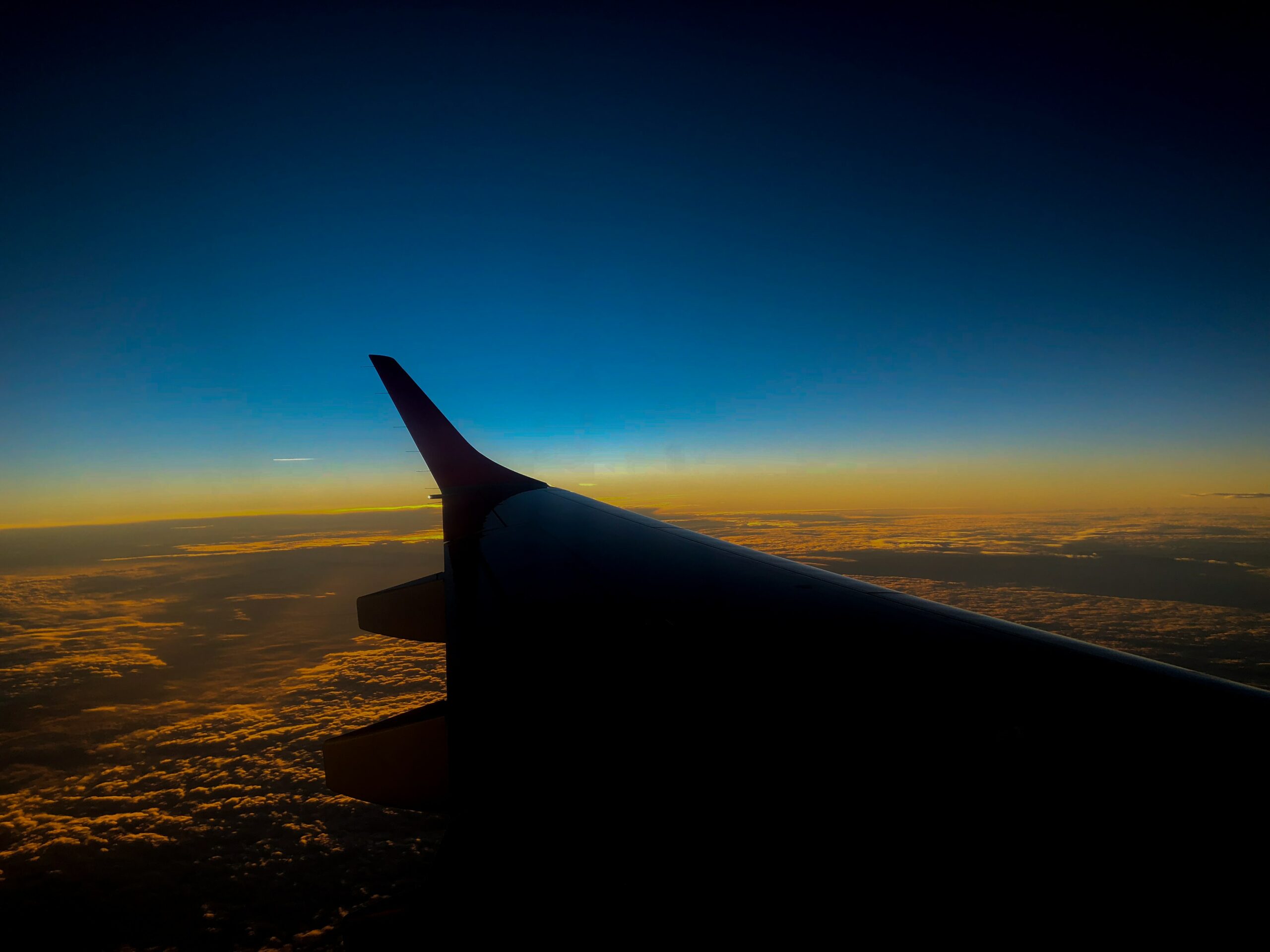 Silhouette of an aircraft wing at dusk