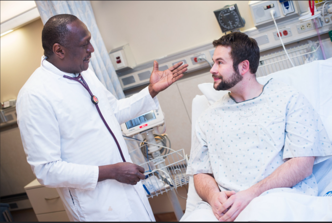 black doctor talking with white patient