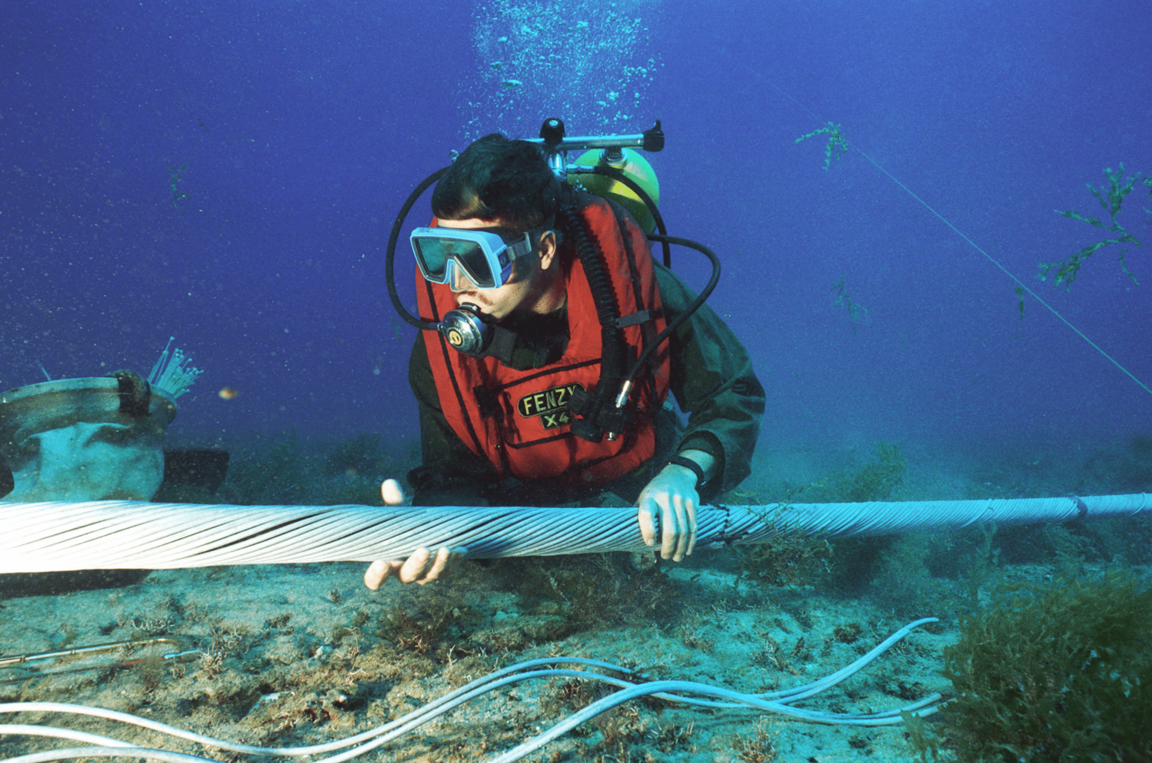Diver inspecting undersea cable