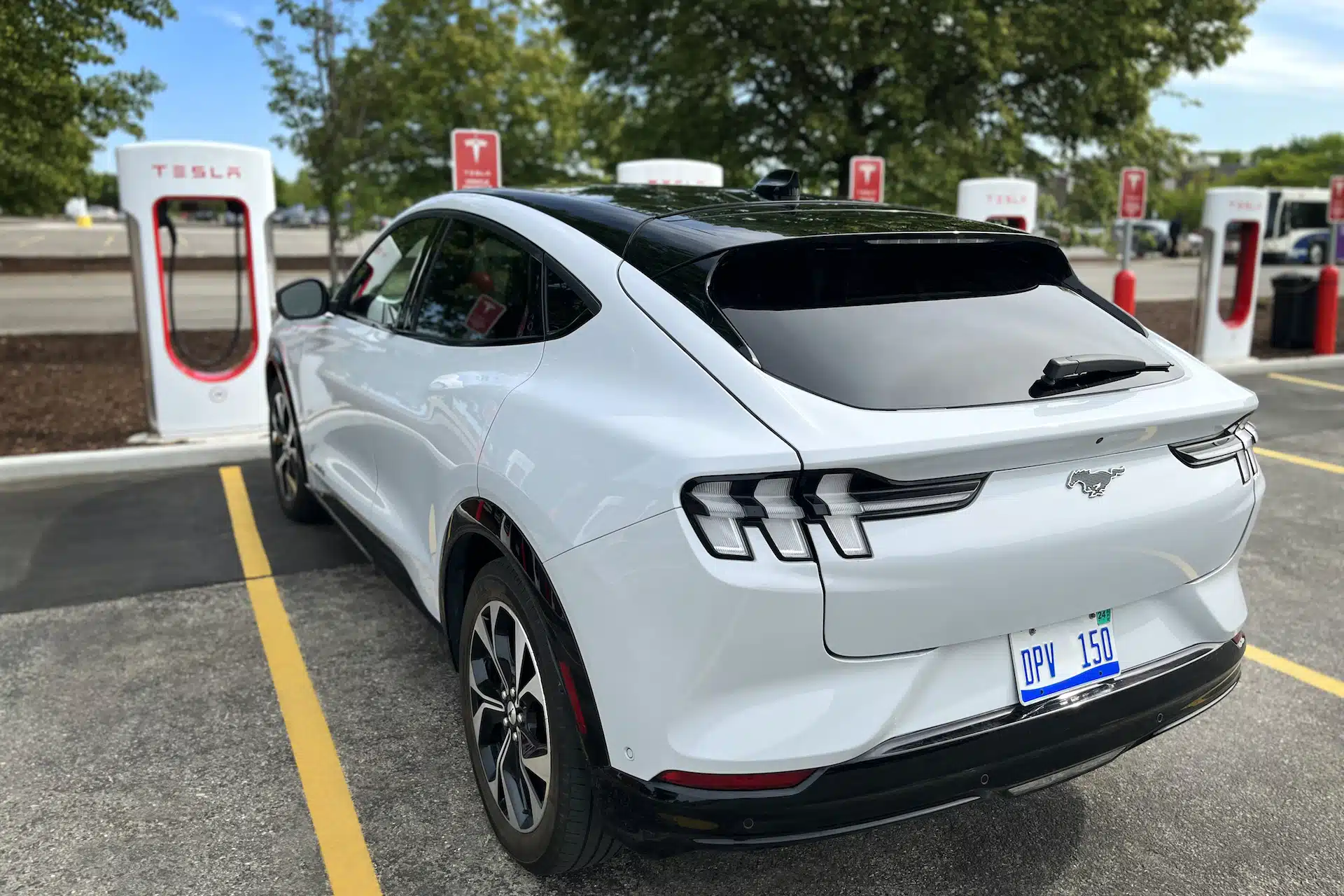 Ford Mustang charging at a Tesla Supercharger (image: Ford)